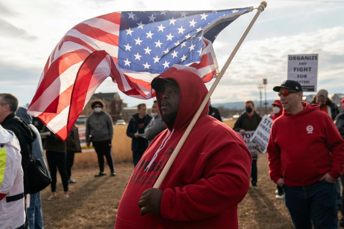 A protester holds a US flag at a pro-unionisation rally in Bessemer