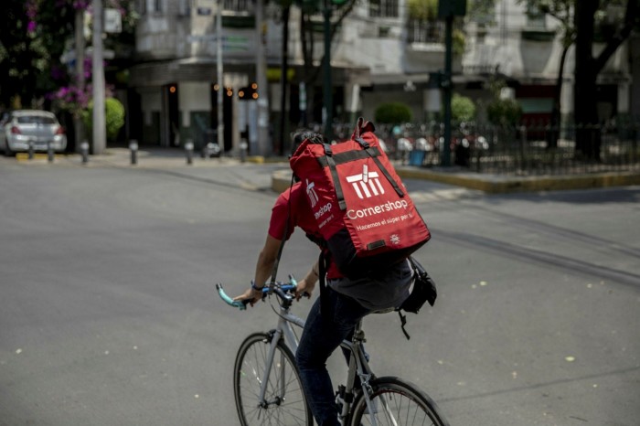 A CornerShop courier riding a bike in Mexico City, Mexico