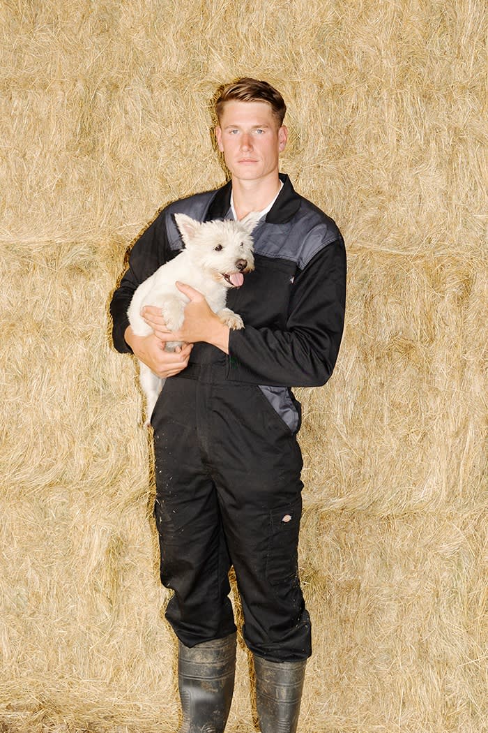 Young with his dog Bella in the farm’s barn