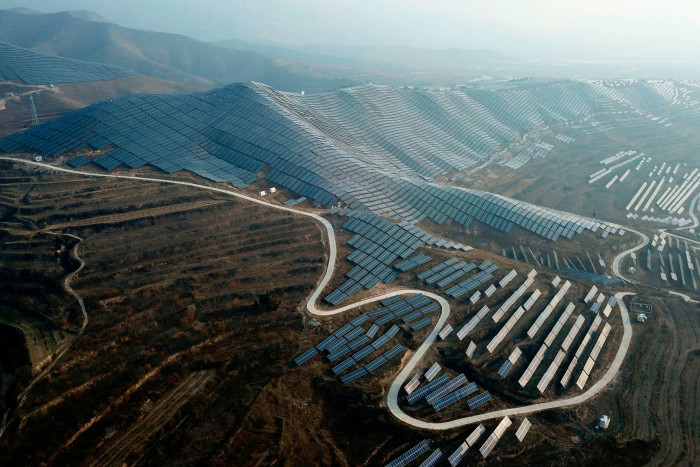 Solar panels cover hills in Shanxi province. Analysts say China is on track to achieve early a national plan to source about 33% of its power from renewables by 2025